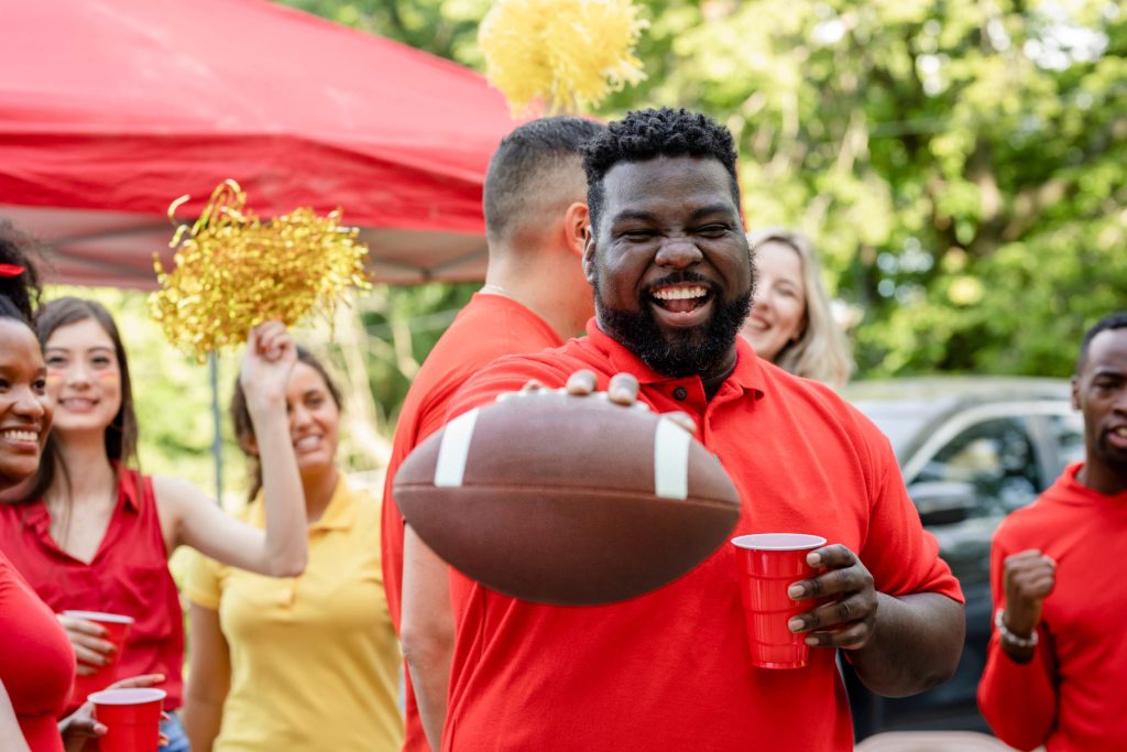 Tailgating Limo Service Austin man with football