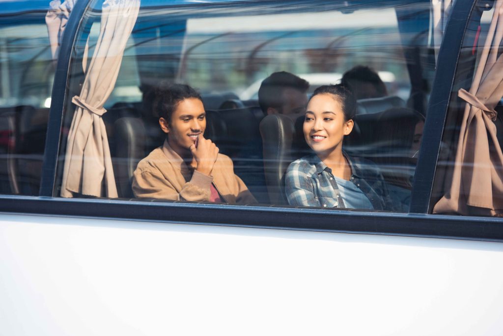 tourists in bus by window