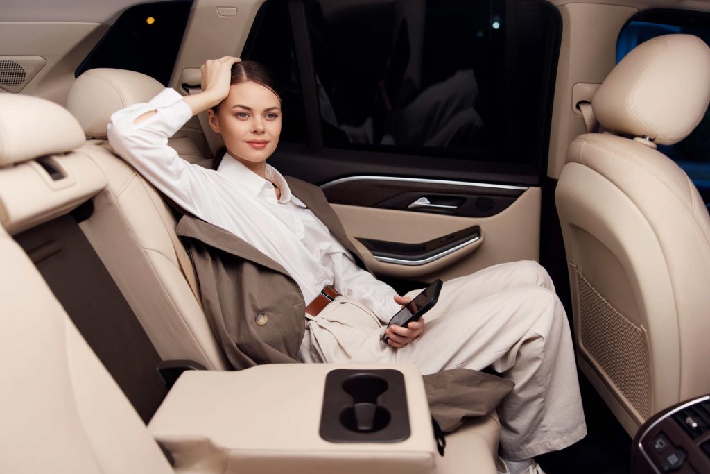 woman sitting in car back seat